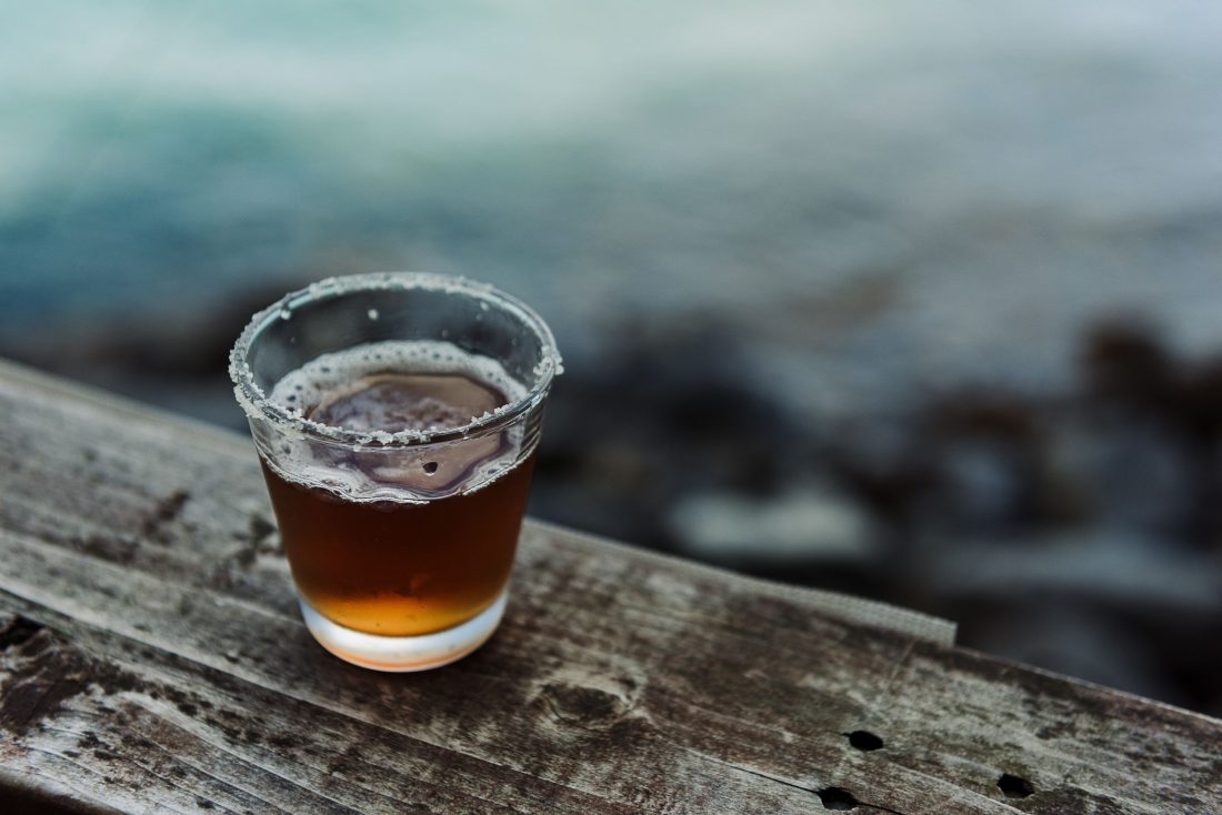 shot glass on the edge of a deck